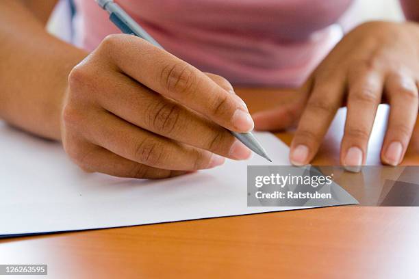close-up of adult hands writing with pen and paper - shorthand stock pictures, royalty-free photos & images