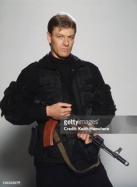 English actor Sean Bean as Alec Trevelyan, holding a Kalashnikov AK-74, in a publicity still for the James Bond film 'GoldenEye', 1995.