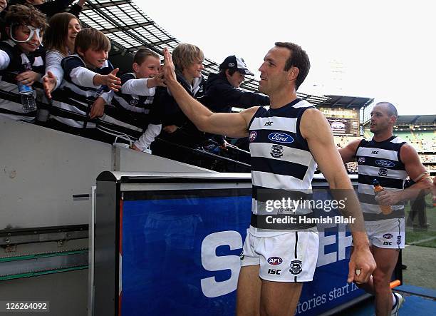 Brad Ottens of the Cats celebrates with the fans after the second preliminary final match between the Geelong Cats and the West Coast Eagles at...