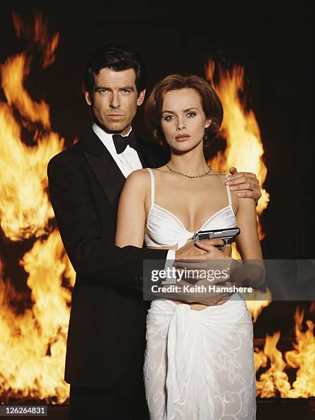 Irish actor Pierce Brosnan stars as James Bond opposite Polish actress Izabella Scorupco in the film 'GoldenEye', 1995. He is holding his iconic...