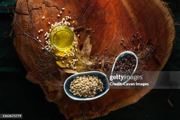 cedar oil and pine cones on wooden background - pine nut stock pictures, royalty-free photos & images