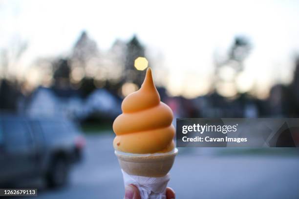 a butterscotch dipped soft serve ice cream - softeis stock-fotos und bilder