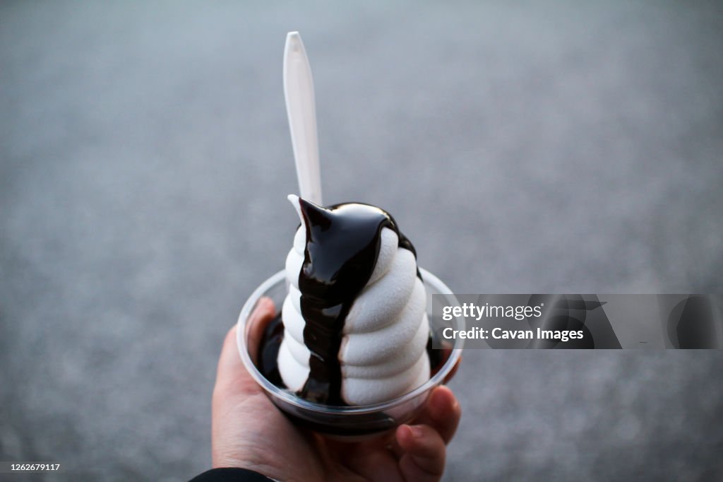 A hot fudge sundae in a plastic cup