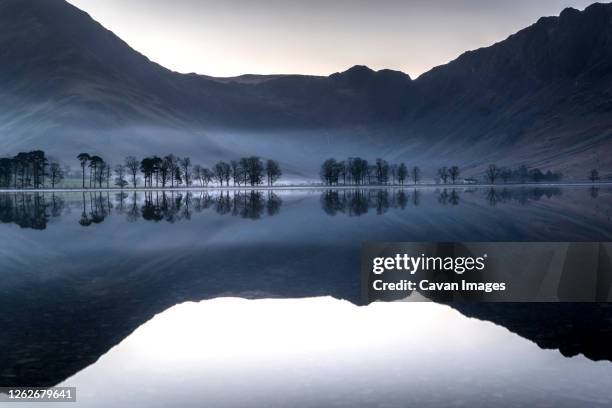 reflections on buttermere lake at dawn - slow shutter stock pictures, royalty-free photos & images