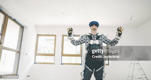 proffesional mover in exoskeleton. using vr headset to plan furnishing - exoskeleton stock pictures, royalty-free photos & images