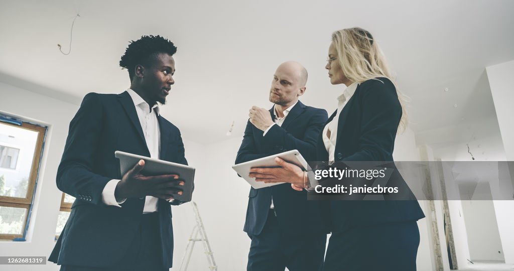 Real Estate Agent Designing Interior With Young Architect High-Res ...