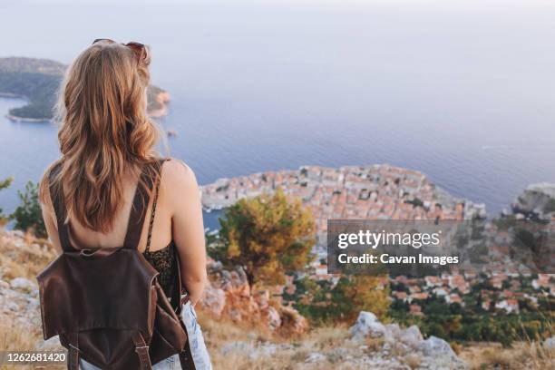 back view of blond woman at dubrovnik viewpoint - bagpack stock pictures, royalty-free photos & images