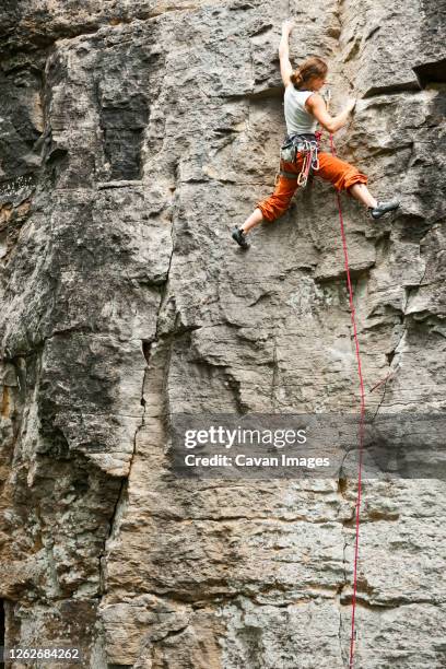 young woman climbing rock face in france - soloing stock pictures, royalty-free photos & images