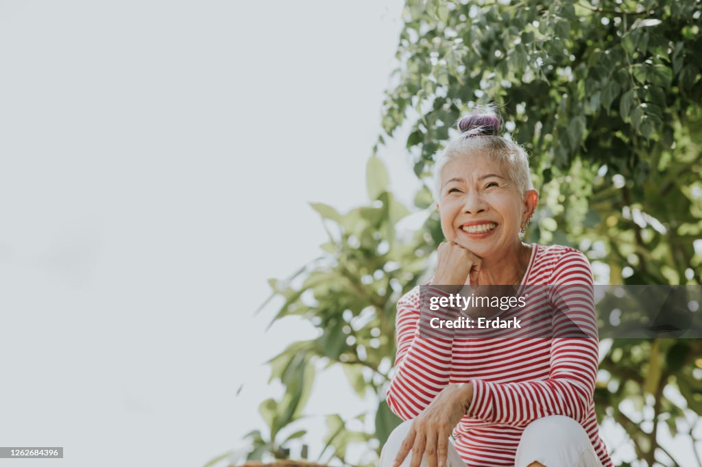 Thai senior hipster portrait beside the garden