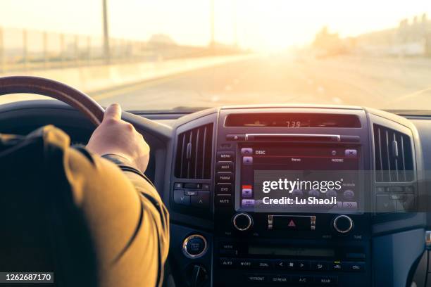 inside the car, driving on the highway at sunset in dubai uae. - auto radio stockfoto's en -beelden