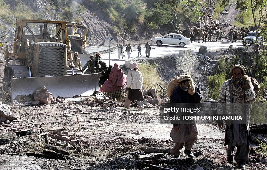 Kashimir residents walk on the opened ro