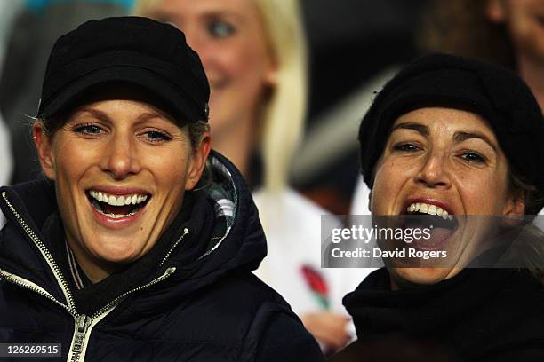 Zara Phillips and a friend watch on from the stand during the IRB 2011 Rugby World Cup Pool B match between England and Romania at Otago Stadium on...