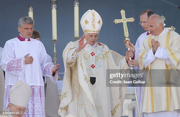 Pope Benedict XVI gestures as he departs at the conclusion of a morning mass at Domplatz square in front of the Erfurter Dom cathedral on September...