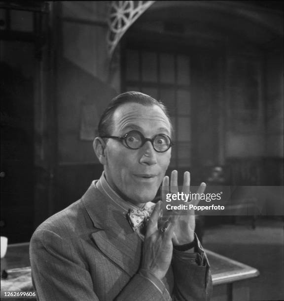 English actor Arthur Askey posed on set during filming of the British mystery thriller film 'The Ghost Train' at Gaumont British Studios in Lime...