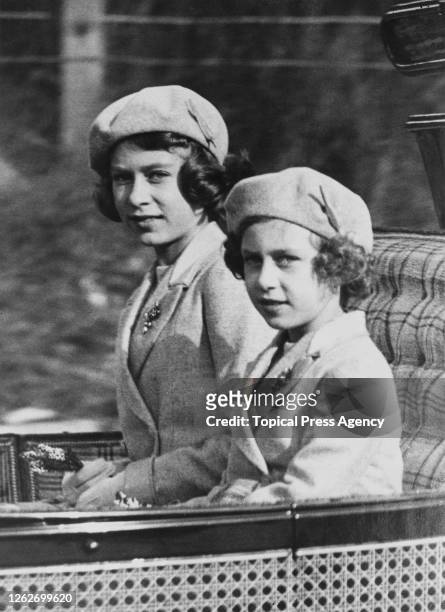 Princess Elizabeth and Princess Margaret ride in a carriage with the King and Queen to Crathie Kirk from Balmoral Castle to attend a morning service,...