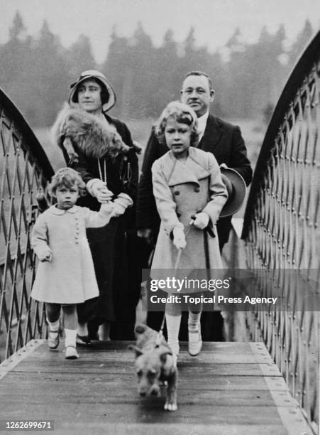 Princess Elizabeth and Princess Margaret along with their mother Queen Elizabeth cross over the railway bridge at Glamis railway station near Forfar...