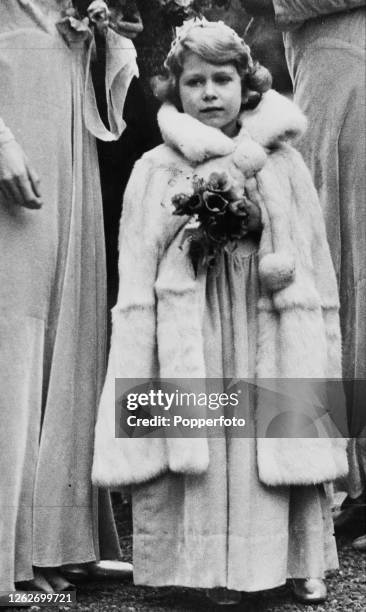 Princess Elizabeth , dressed as a bridesmaid, attends the wedding of Lady May Cambridge and Captain Henry Abel Smith at the village church of St Mary...