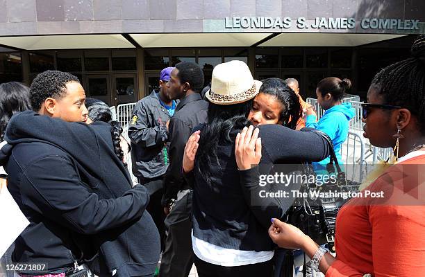 Students embrace following a service at the gym after an 18-year-old Bowie State University student was fatally stabbed Thursday night. One of the...