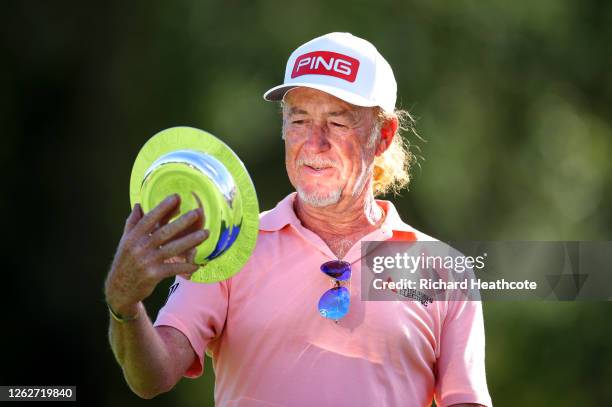 Miguel Angel Jimenez of Spain looks at award he was given after making his 707th European tour start, a tour appearance record during Day One of the...