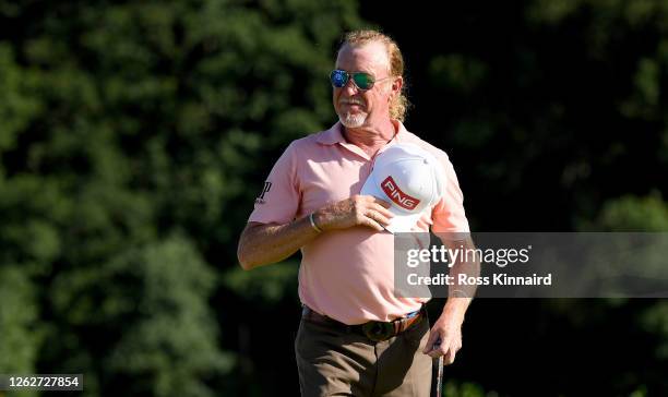 Miguel Angel Jimenez of Spain acknowledges his fellow players as he walks on to the 18th green during the first round of the Hero Open at Marriott...
