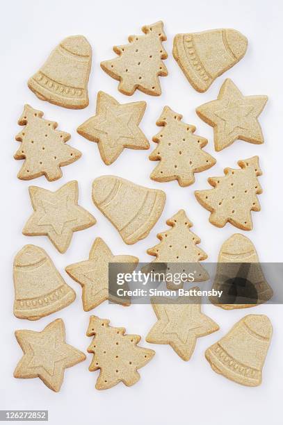 christmas themed biscuits on white background - buttermilchkeks stock-fotos und bilder