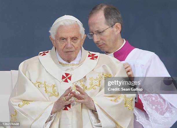 Pope Benedict XVI gets assistance while leading a morning mass at Domplatz square in front of the Erfurter Dom cathedral on September 24, 2011 in...