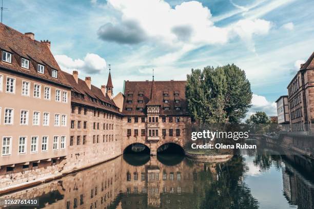 a river goes underneath the old bulding - nuremberg stock pictures, royalty-free photos & images