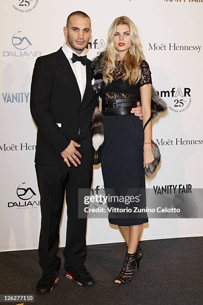 Maryna Linchuk and guest attend amfAR MILANO 2011 at La Permanente on September 23, 2011 in Milan, Italy.