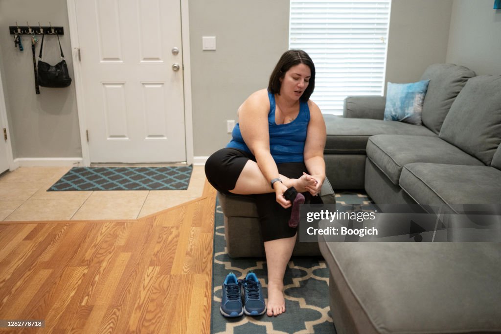 Caucasian Woman in 30s Putting on Sneakers to Go for a Walk