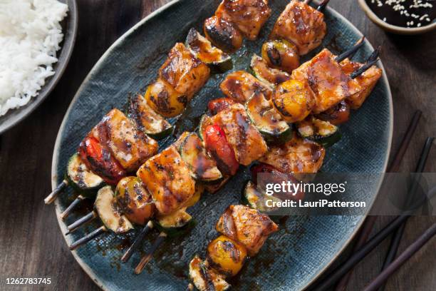 bbq teriyaki glazed salmon skewers with zucchini, tomatoes and rice - kebab stock pictures, royalty-free photos & images