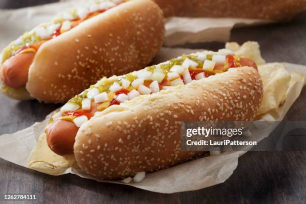 hotdog with, ketchup, mustard, relish, onions and potato chips - relish stock pictures, royalty-free photos & images