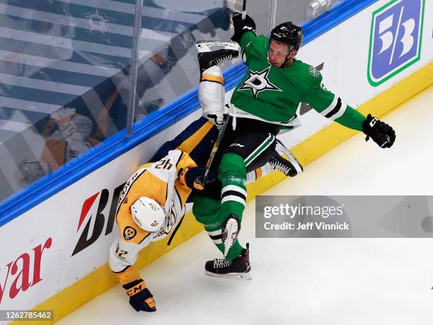 Jamie Oleksiak of the Dallas Stars checks Colin Blackwell of the Nashville Predators during the second period in an exhibition game prior to the 2020...