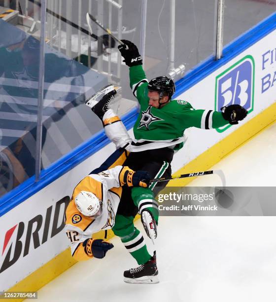 Jamie Oleksiak of the Dallas Stars checks Colin Blackwell of the Nashville Predators during the second period in an exhibition game prior to the 2020...