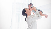 Portrait of asian mother lifting and playing with newborn baby, baby talking to mother. Health care family love together. Asian girl lifestyle. Asia mother's day concept