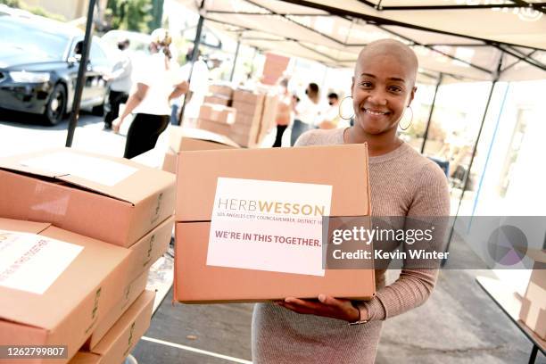 Actress Tiffany Haddish helps donate Chromebook computers to students in foster care during a drive-thru giveaway event at Wessons's district office...