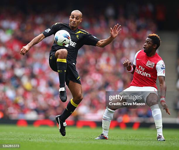 Darren Pratley of Bolton Wanderers controls the ball as Alex Song of Arsenal looks on during the Barclays Premier League match between Arsenal and...