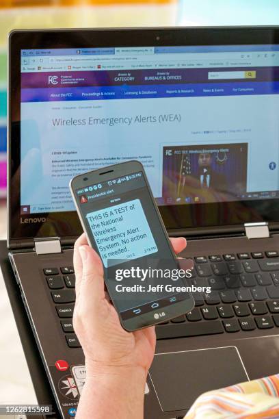 Florida, Miami Beach, National Wireless Emergency Alert System, smartphone and laptop.
