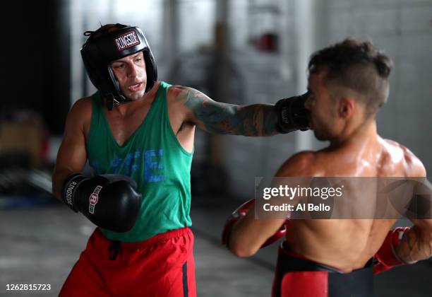 Amateur kickboxer Sal Carillo spars with New York Golden Gloves boxer Dennis Guerrero during a final boxing workout at Jetty gym on July 30, 2020 in...