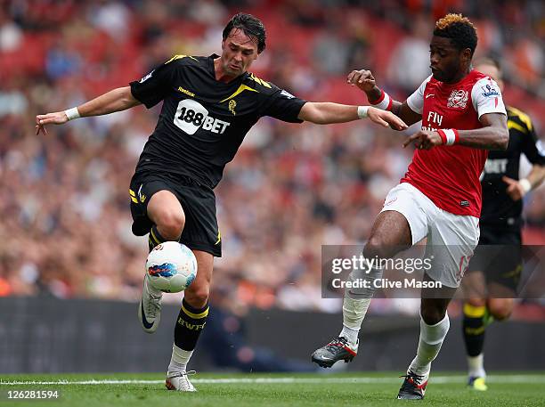 Chris Eagles of Bolton Wanderers holds off a challenge from Alex Song of Arsenal during the Barclays Premier League match between Arsenal and Bolton...