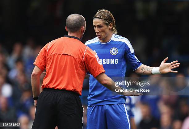Fernando Torres of Chelsea talks to referee Mike Dean during the Barclays Premier League match between Chelsea and Swansea City at Stamford Bridge on...