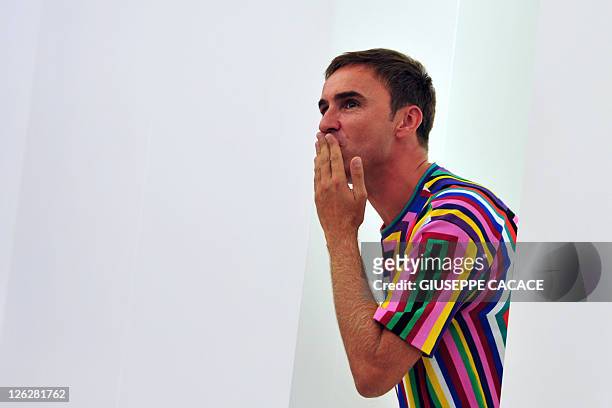 Belgian fashion designer Raf Simons acknowledges the audience at the end of Jil Sander Spring-Summer 2012 ready-to-wear collection on September 24,...