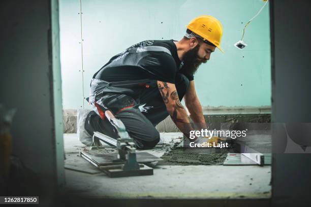 professional installer at work - tiler stock pictures, royalty-free photos & images