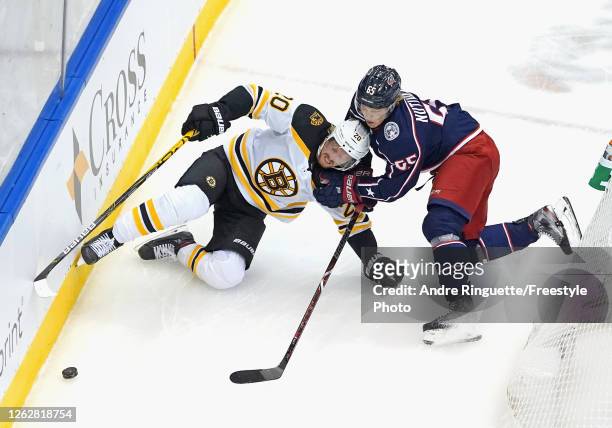 Markus Nutivaara of the Columbus Blue Jackets checks Joakim Nordstrom of the Boston Bruins during the second period in an exhibition game prior to...