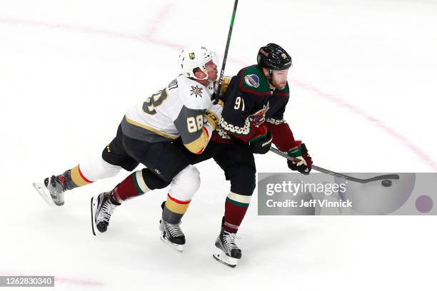 Nate Schmidt of the Vegas Golden Knights hits Taylor Hall of the Arizona Coyotes in the first period during an exhibition game prior to the 2020 NHL...