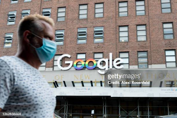 Man wearing a mask walks past the Google officers in Chelsea as the city continues Phase 4 of re-opening following restrictions imposed to slow the...