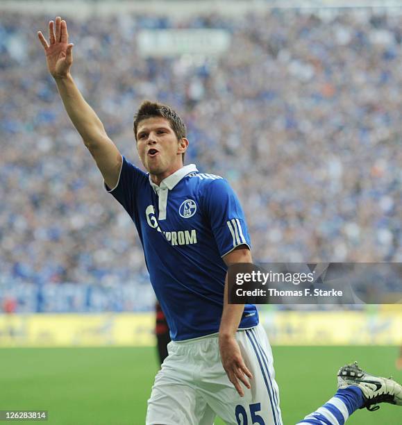 Klaas-Jan Huntelaar of Schalke celebrates during the Bundesliga match between FC Schalke 04 and SC Freiburg at Veltins Arena on September 24, 2011 in...