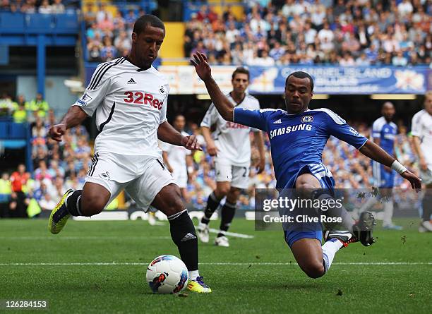 Ashley Cole of Chelsea tackles Scott Sinclair of Swansea City during the Barclays Premier League match between Chelsea and Swansea City at Stamford...