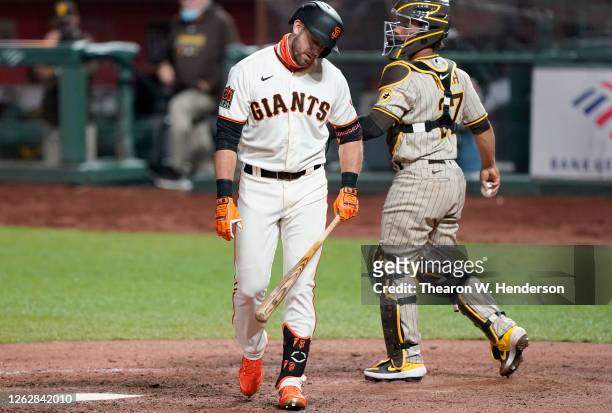 Evan Longoria of the San Francisco Giants reacts after striking out with the bases loaded against the San Diego Padres in the bottom of the seventh...