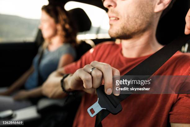 close up of fastening seatbelt in a car. - fasten stock pictures, royalty-free photos & images
