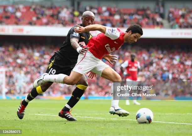 Mikel Arteta of Arsenal is challenged by Nigel Reo-Coker of Bolton Wanderers during the Barclays Premier League match between Arsenal and Bolton...